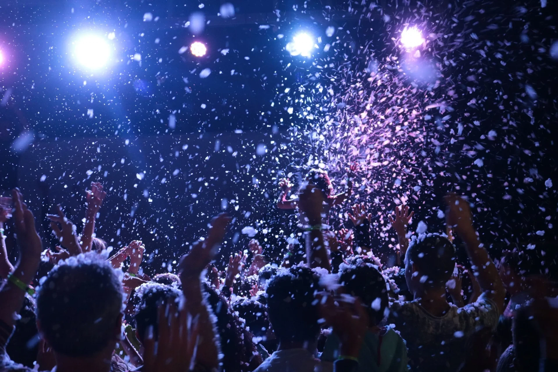 Real snow machine falling over a crowd at a nighttime FoamHype snow party