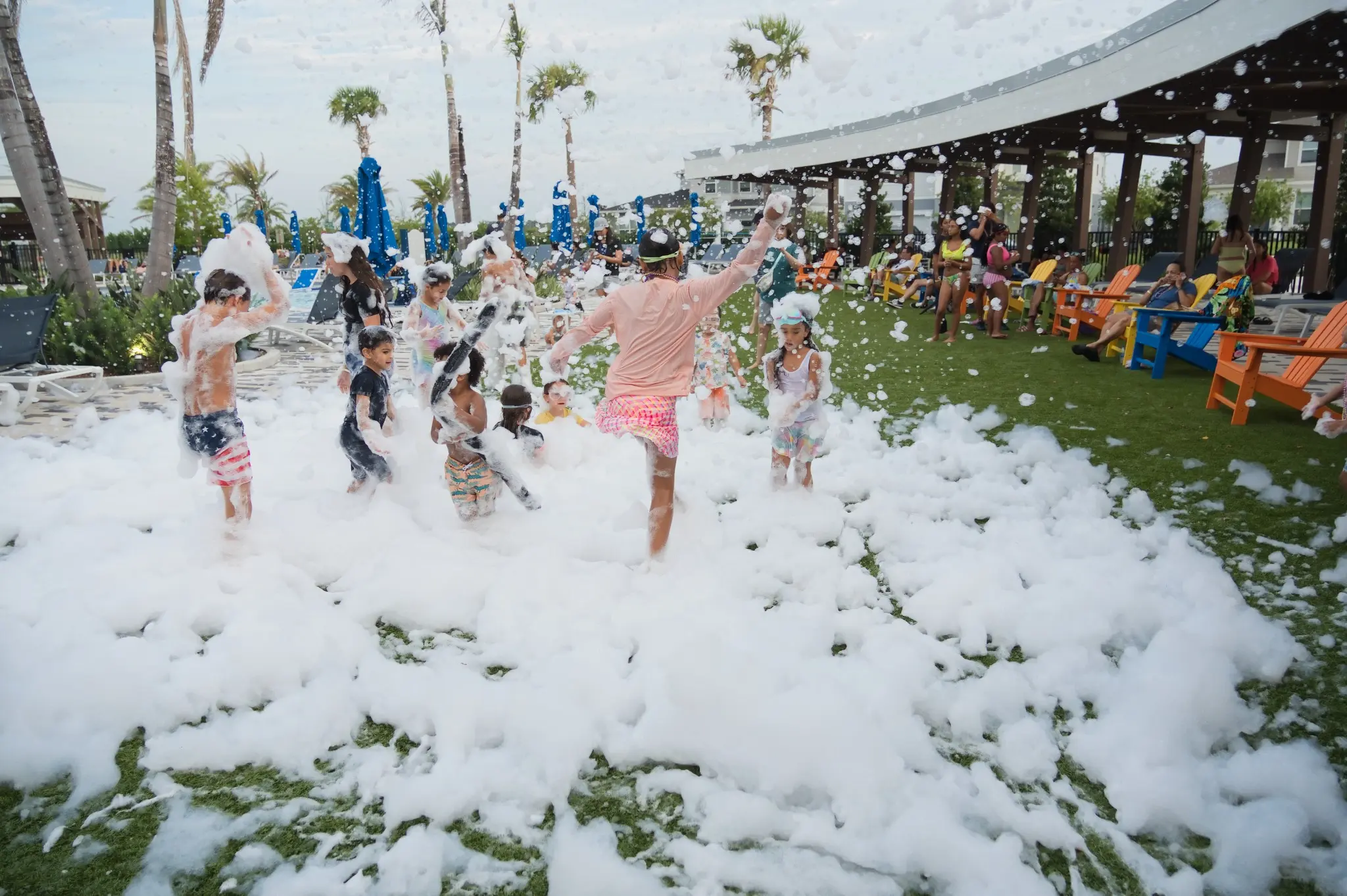 Large group of kids enjoying a FoamHype foam party at a Central Florida community field event
