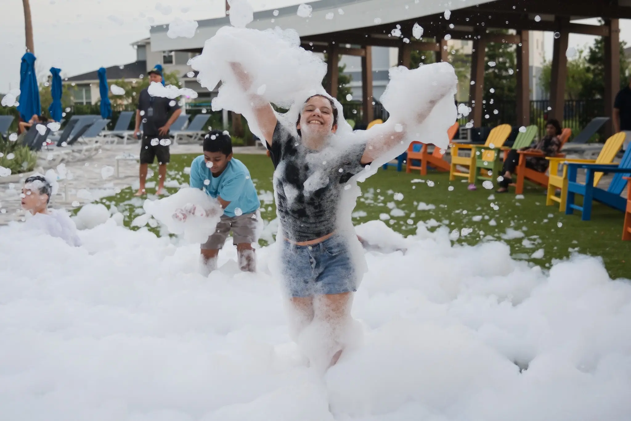 Teen celebrating in mountains of foam at a FoamHype event